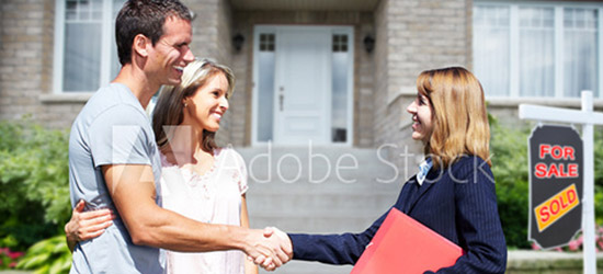 Adobe stock photo of real estate agent shaking a couple's hand